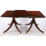 George III style mahogany twin pillar dining table, having a rounded-rectangular reeded edge top,
