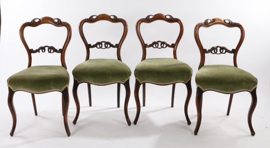 Set of four Victorian mahogany balloon back side chairs, the undulating top rail carved with