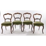 Set of four Victorian mahogany balloon back side chairs, the undulating top rail carved with