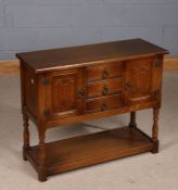 20th century oak side cupboard, the rectangular top above a pair of linen fold decorated doors,