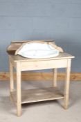 Victorian style stripped pine washstand, having porcelain basin with shell motif, above a single