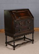 20th century oak geometric bureau, having sloping fall, fitted with two short and one long drawer