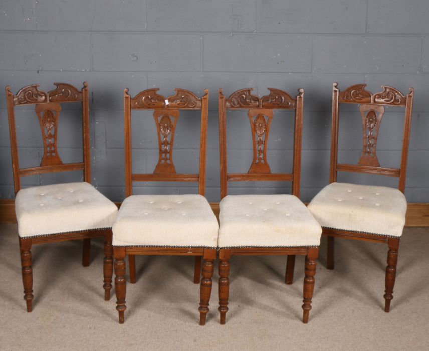 Set of four Art Nouveau oak dining chairs, having swan neck and stylised floral back rest, button