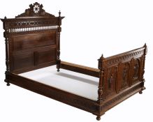 Late 19th Century carved chestnut bed, the headboard carved with flower heads above spindles and