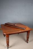Victorian mahogany extending dining table, the rectangular top above turned legs, with two extra