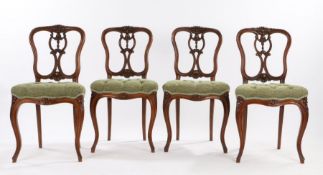 Set of four Victorian walnut parlour chairs, the foliate carved cresting rails above shell and