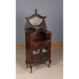 Victorian mahogany display cabinet, the arched pediment with scroll carved finial and bevelled