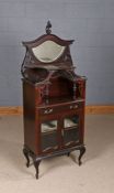 Victorian mahogany display cabinet, the arched pediment with scroll carved finial and bevelled