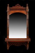 Victorian wall mirror, the moulded frieze above a bevelled mirror plate, flanked by turned