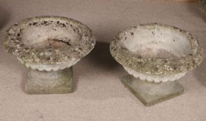 Pair of reconstituted stone garden planters, of circular form with fluted decoration, raised on