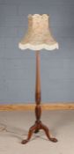 20th century carved mahogany standard lamp, the tapering reeded column raised on three claw on