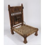 Indian Pida Rajasthani low chair, the back with finials above a carved crest, depicting birds and