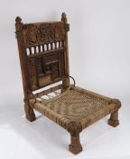 Indian Pida Rajasthani low chair, the back with finials above a carved crest, depicting birds and