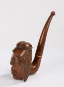 Large carved wooden novelty pipe, the bowl modelled as a native American wearing a feather