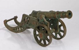 Brass model cannon on a roundel pierced stand, 46cm long