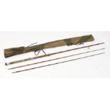 Cork handled spinning rod, with two top sections, housed in a camouflage slip case, the rod 228cm