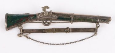 White metal and agate mounted brooch in the form of a rifle, 10.5cm wide