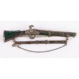 White metal and agate mounted brooch in the form of a rifle, 10.5cm wide