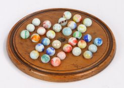 Boxwood solitaire board and marbles, the board 19cm diameter