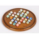 Boxwood solitaire board and marbles, the board 19cm diameter