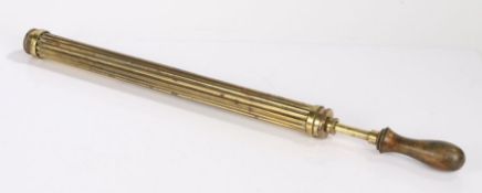 Brass air cane pump, the turned wooden handle above the reeded brass body, 64cm long