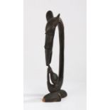 Tanzania Makonde figure, depicting a zoomorphic head above a hand holding a bulbous pot, 47cm high