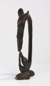 Tanzania Makonde figure, depicting a zoomorphic head above a hand holding a bulbous pot, 47cm high