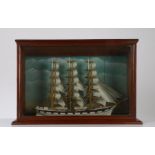 Model of a three masted ship in full sail, housed in a glazed mahogany case, 56.5cm wide, 37cm high,