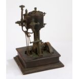 19th Century stationary steam engine, with coopered boiler above the cast frame and fly wheel,
