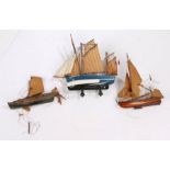 Three small wooden and paint decorated model sailing boats, the largest 22cm wide (AF) (3)