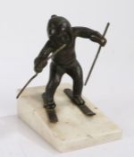 Early 20th Century continental bronze figure depicting a young boy skiing, on a sloped white