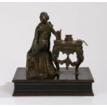 Bronze figure, of a gentleman seated on  table with a draped cloth, his foot rested on a cushion,