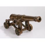 Bronze cannon, the ribbed barrel on a pierced frame with four wheels, 48cm wide