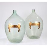 Pair of substantial glass demijohns, the bulbous bodies with gilt scrolled ribbon decoration