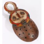 Ivory Coast Baule mask, having horns above a polychrome face with a rectangular carved mouth, the