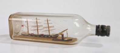 Ships in a bottle, depicting a three master British sailing vessel and a tug boat, 27cm wide