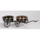 Silver plated novelty wine coaster trolley, the two coasters mounted to a four wheeled trolley