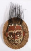 Papua New Guinea turtle shell mask, Sepik River region, the polychrome face inlaid with shells, with