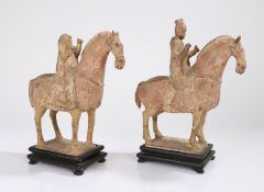 Near pair of Chinese pottery horse and riders, Tang Dynasty, with pale red painted bodies with