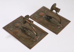 Pair of Arts and Crafts copper wall sconces in the manner of Macintosh, the foliate embossed