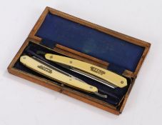 Pair of Gotta cut throat razors, housed in a blue velvet lined wooden box