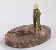 Art Deco chryselephantine figure depicting a young boy with his hands in his pockets, on a marble