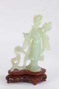 Chinese jade style figure, in the form of a female figure standing holding a tray, on hardwood base,