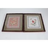 Pair of 20th century Chinese silk embroideries, each of flowers within green fabric borders,