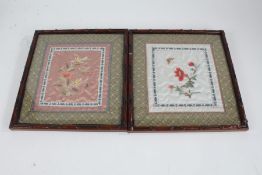 Pair of 20th century Chinese silk embroideries, each of flowers within green fabric borders,
