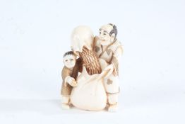 Japanese Meiji period carved ivory netsuke, in the form of a man and boy pouring grain into a