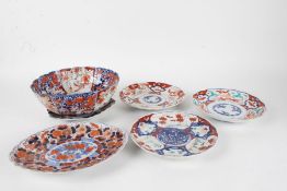 Five various Japanese Imari plates, together with an Imari bowl, all decorated in the typical taste,