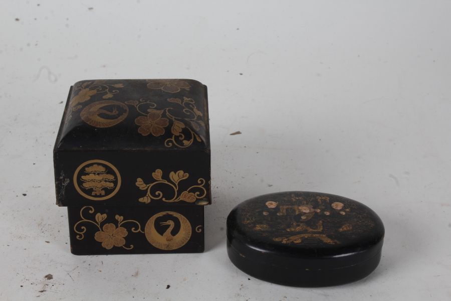 Chinese black lacquered box, of oval form, the lift up lid with three figures in a garden setting,