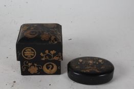 Chinese black lacquered box, of oval form, the lift up lid with three figures in a garden setting,