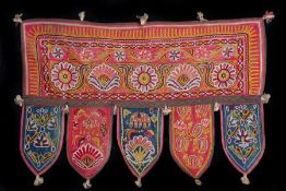 Indian textile hanger, decorated with flowers and elephants on a red and blue ground, 65cm long